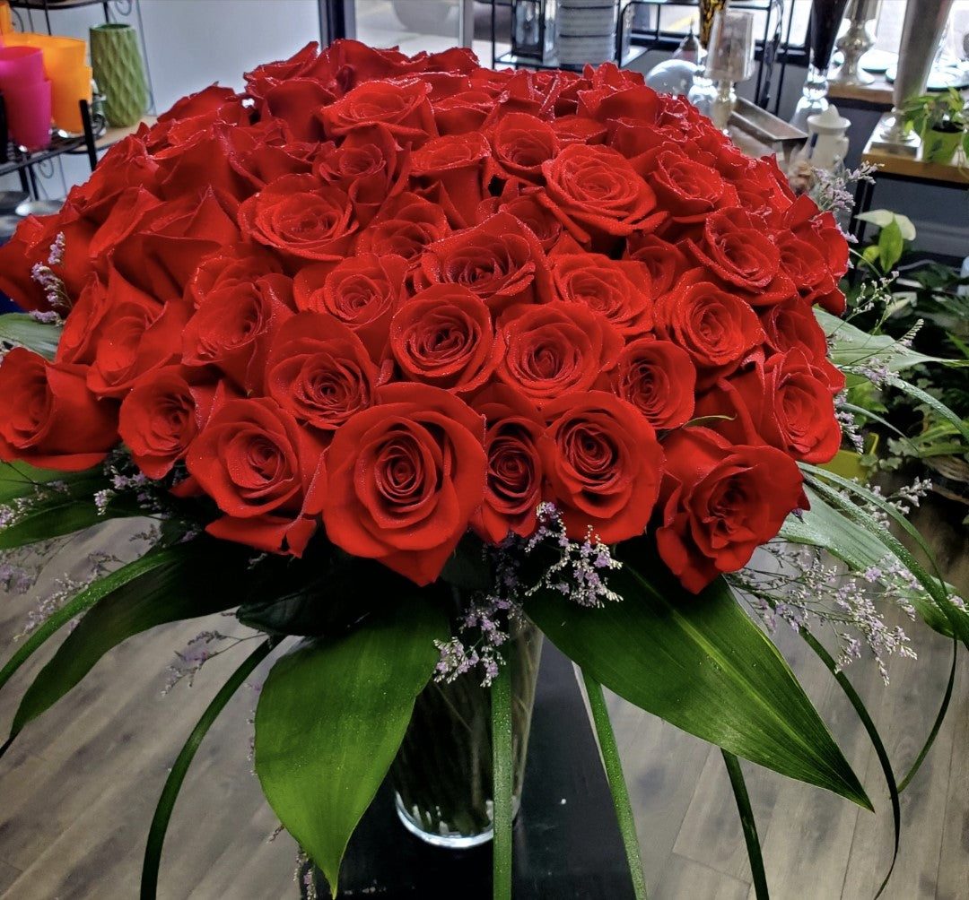 100 Red roses in a vase